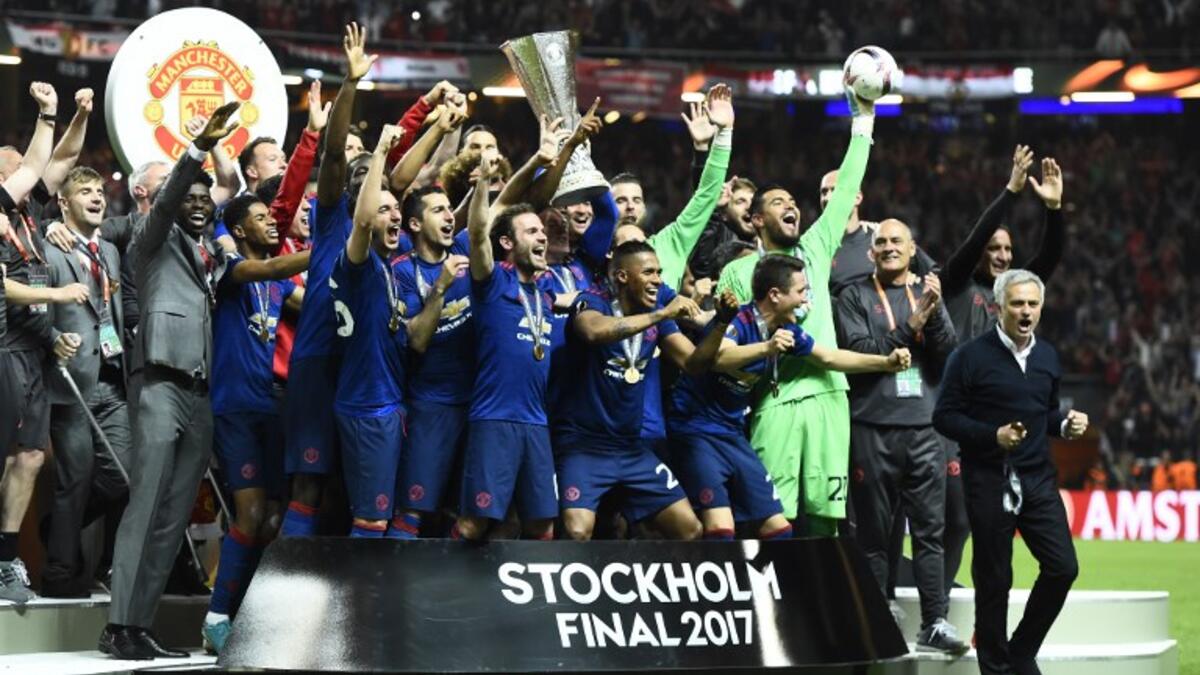 Manchester United's players celebrate with the trophy after winning the UEFA Europa League final football match Ajax Amsterdam v Manchester United on May 24, 2017 at the Friends Arena in Solna outside Stockholm.
Jonathan NACKSTRAND / AFP