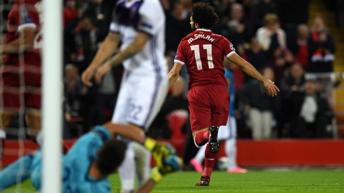 Liverpool's Egyptian midfielder Mohamed Salah (R) celebrates after scoring the opening goal of the UEFA Champions League Group E football match between Liverpool and NK Maribor at Anfield in Liverpool, north-west England on November 1, 2017.
Paul ELLIS / AFP