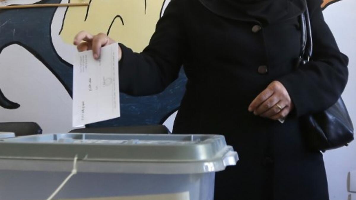A woman casts her ballot for Syria's first local elections since 2011, on September 16, 2018 in the southern Eastern Ghouta, on the eastern outskirts of the capital Damascus. (LOUAI BESHARA / AFP)