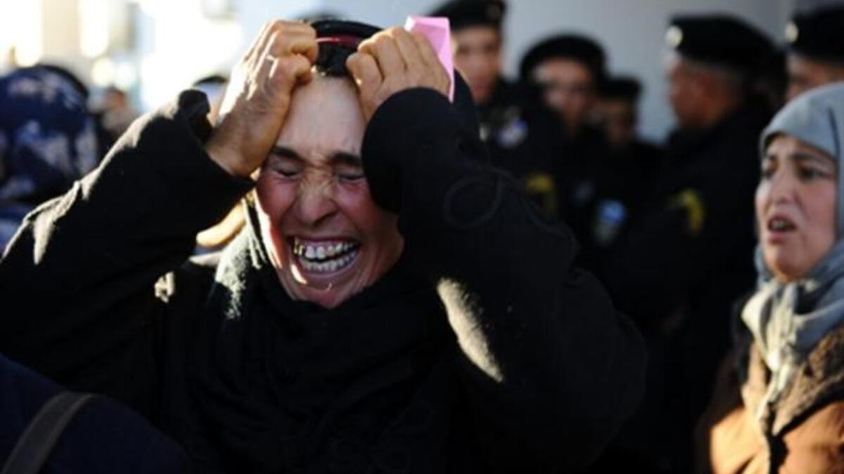 A woman cries in front of the prefecture as she waits with other people to meet the governor. Tunisian President Zine El Abidine Ben Ali described weekend rioting as "terrorist acts" and blamed "gangs of thugs" for the explosion of violence.