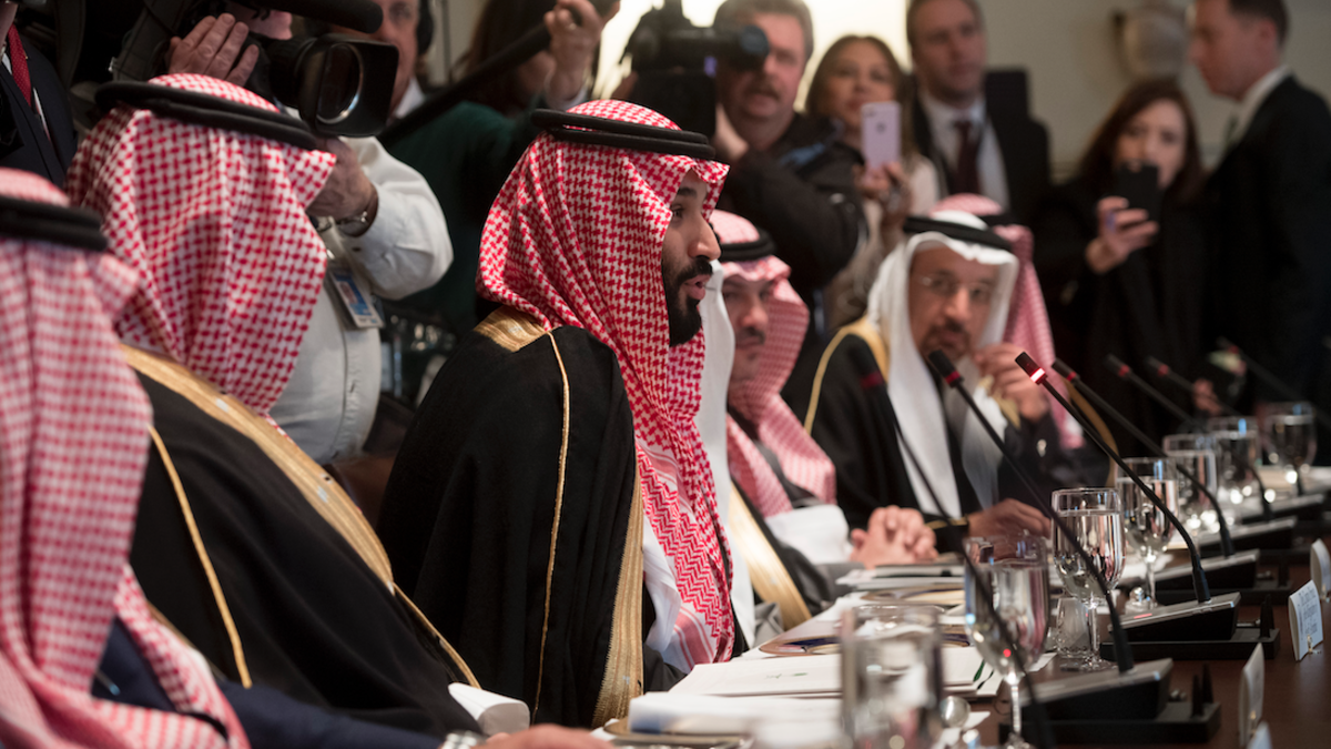Saudi Arabia's Crown Prince Mohammed bin Salman (C) speaks alongside members of his delegation during a lunch meeting with US President Donald Trump in the Cabinet Room of the White House in Washington, DC, March 20, 2018.  (SAUL LOEB / AFP)