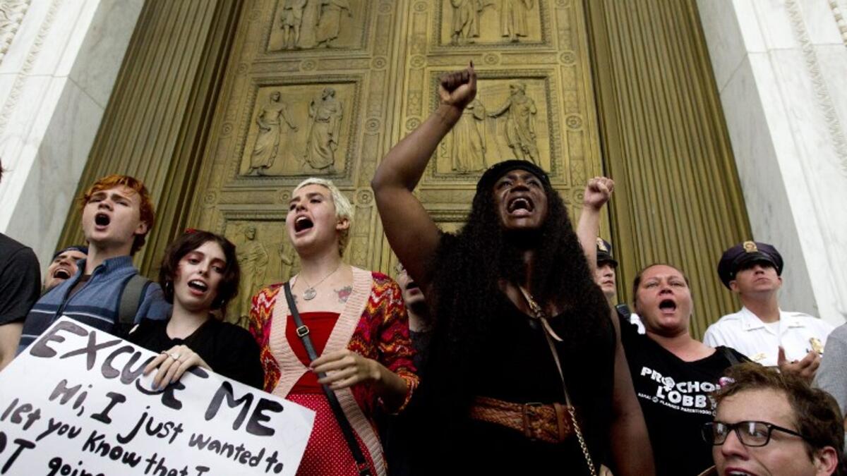 Demonstrators block the main entrance door as they take the steps of the US Supreme Court to protest against the appointment of Supreme Court nominee Brett Kavanaugh in Washington DC, on October 6, 2018. (Jose Luis Magana / AFP)