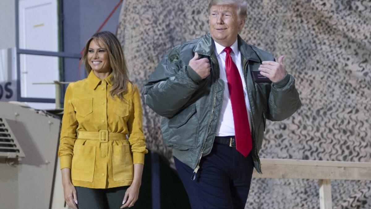 US President Donald Trump and First Lady Melania Trump arrive to speak to members of the US military during an unannounced trip to Al Asad Air Base in Iraq on December 26, 2018. SAUL LOEB / AFP