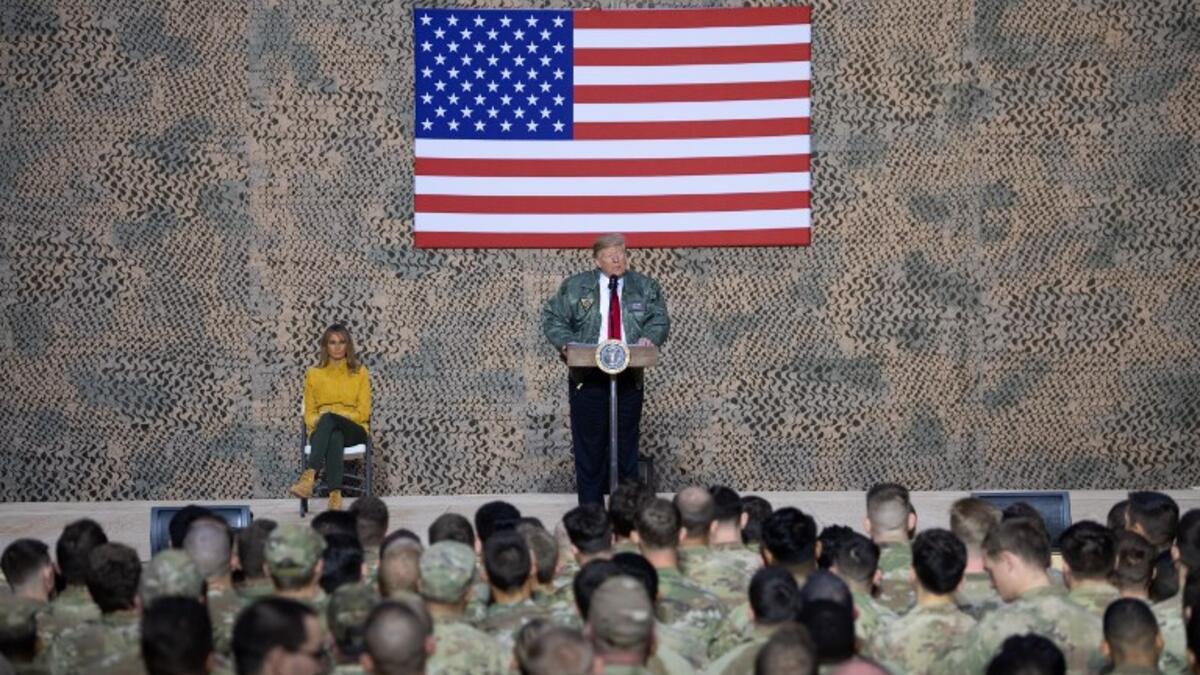 US President Donald Trump speaks to members of the US military during an unannounced trip to Al Asad Air Base in Iraq, December 26, 2018. 
SAUL LOEB / AFP