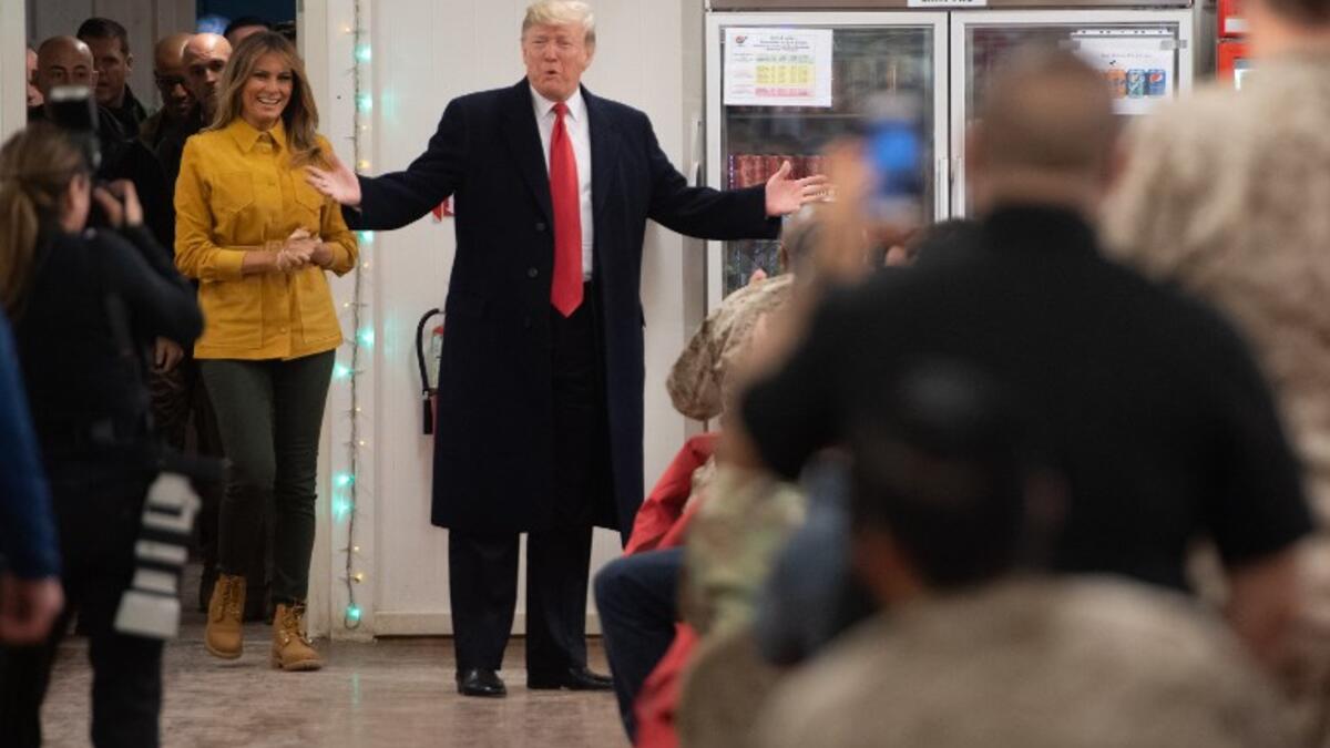 US President Donald Trump and First Lady Melania Trump arrive to visit members of the US military during an unannounced trip to Al Asad Air Base in Iraq on December 26, 2018.
SAUL LOEB / AFP