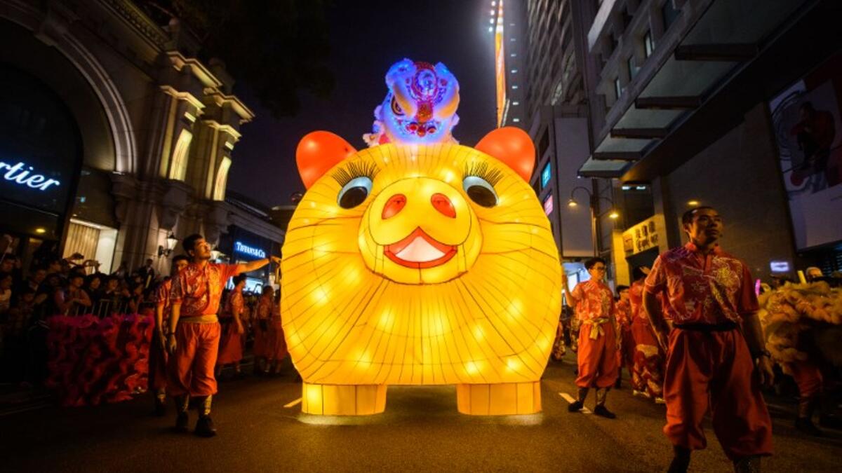 Performers walk with a lit model of a pig during the annual Lunar New Year parade in the Kowloon district of Hong Kong on February 5, 2019, to mark the Year of the Pig. 
Anthony WALLACE / AFP