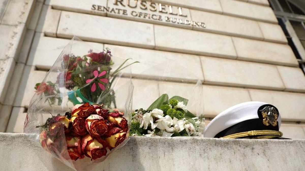 An impromptu memorial of flowers and a U.S. Navy officers hat stands outside of the Russell Senate Office Building in honor of Sen. John McCain (R-AZ) August 27, 2018 in Washington, DC. (AFP)
