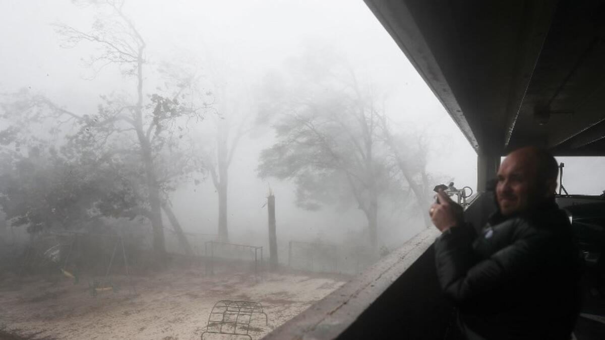 Derik Kline takes shelter in a parking garage as Hurricane Michael passes through the area on October 10, 2018 in Panama City, Florida. (Joe Raedle/Getty Images/AFP )
