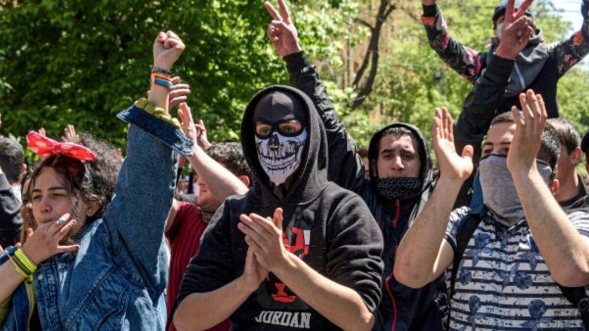 Demonstrators in Armenia march to protest the shift of the former president into the position of prime minister (AFP/File Photo)