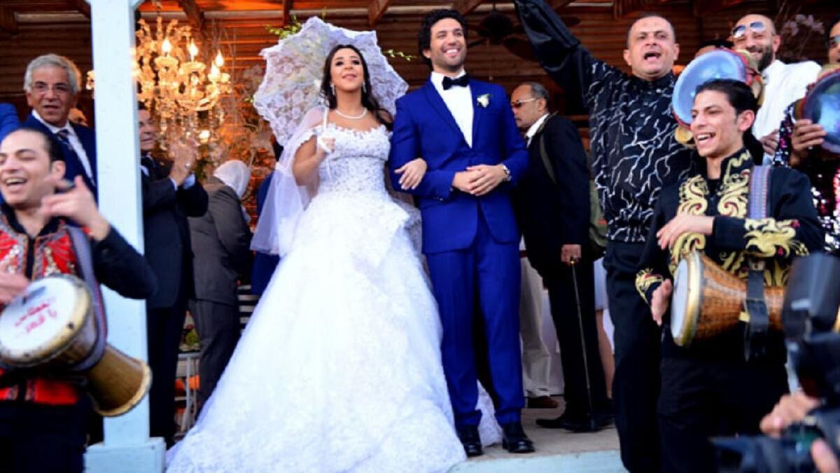 ارتدت ايمي سمير غانم "العروس" فستان  عاري الكتفين ومنفوش من تصميم هاني البحيري، واعتمدت تسريحة شعر ناعمة مع تاج رقيق. اما حسن الرداد "العريس" فارتدى بدلة باللون الأزرق، بالإضافة إلى بابيون باللون الأسود.