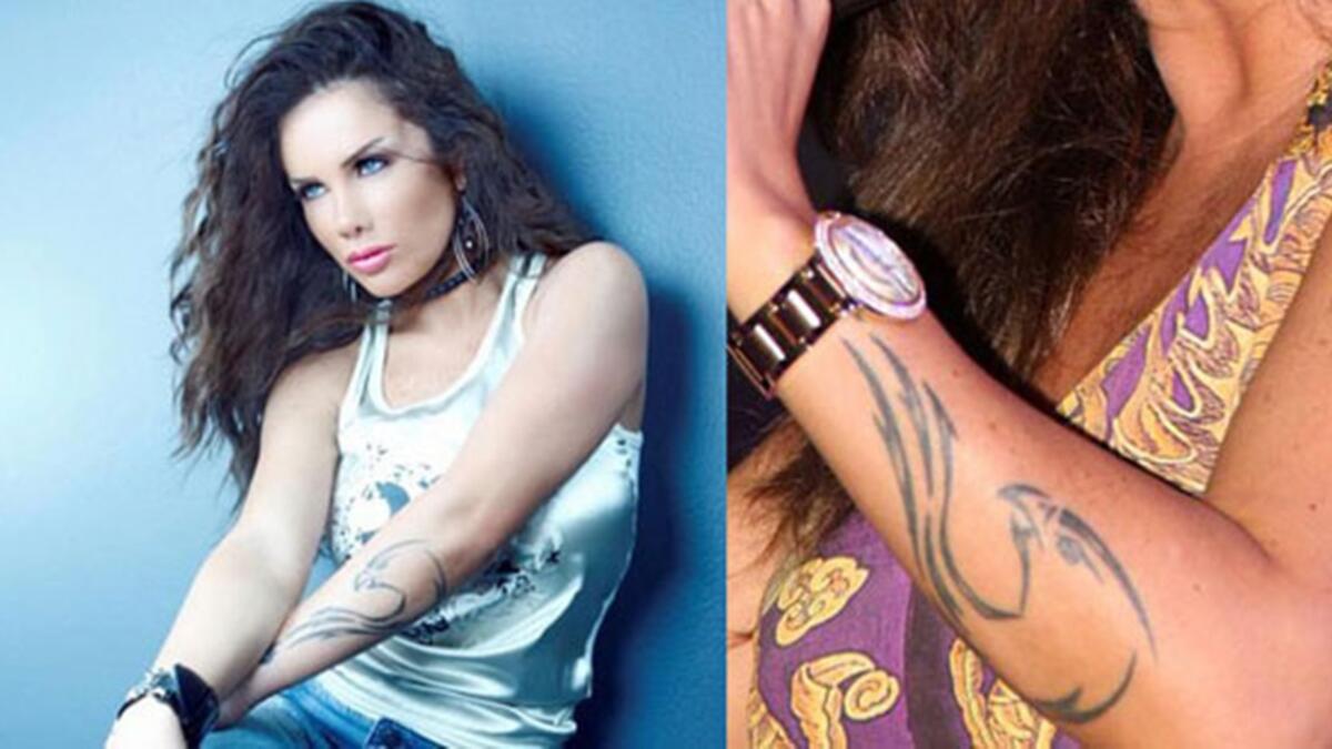 الفنانة اللبنانية نيكول سابا رسمت تاتو مميز وغريب لشكل تنين على طول ذراعها