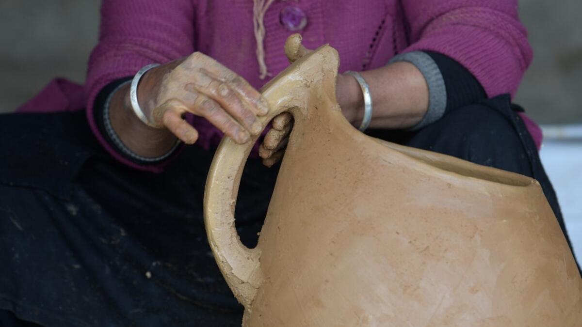 Sabiha Ayari, a Tunisian potter in her fifties, works in the village of Sejnane in the northern Tunisian province of Bizerte, about 120 kilometres (75 miles) west of the capital Tunis.  FETHI BELAID / AFP