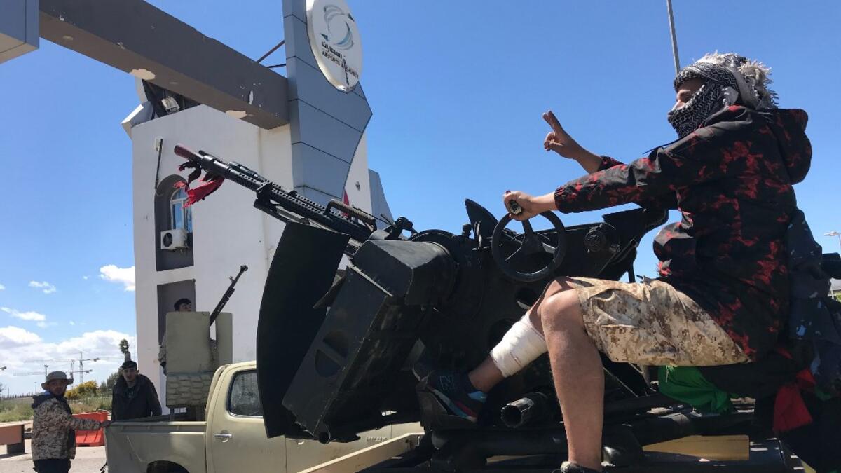 Forces loyal to the internationally recognised Libyan Government of National Accord (GNA) are pictured at the entrance gate leading to Tripoli's old airport on April 8, 2019. Mahmud TURKIA / AFP
