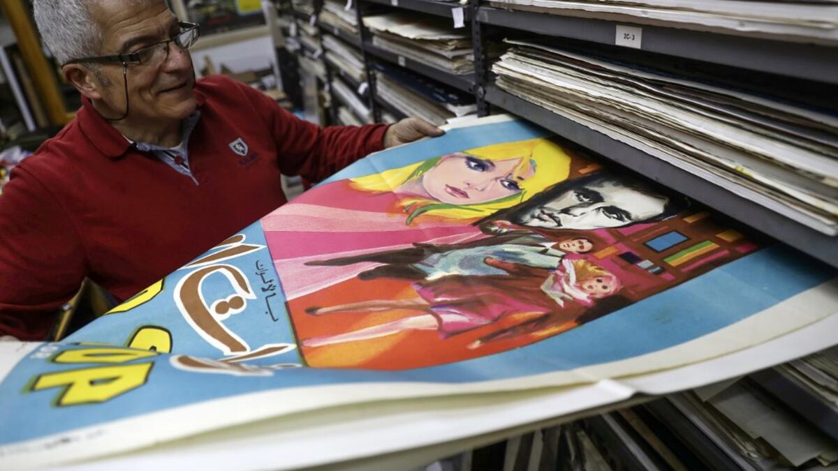 Abboudi Abu Jawdeh shows part of his vintage cinema poster collection at his office in the Lebanese capital Beirut  JOSEPH EID / AFP