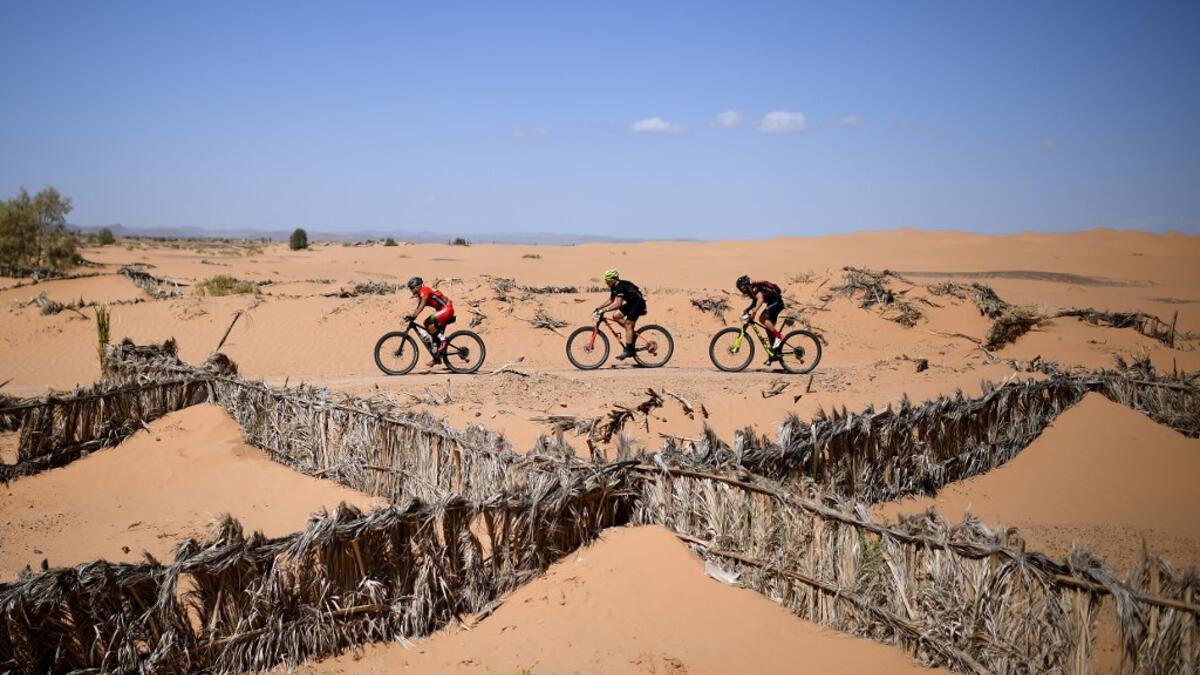 Competitors ride their bikes during Stage 6 of the 14th edition of Titan Desert 2019 mountain biking race between El-Jorf and Erfoud in Morocco on May 3, 2019.  FRANCK FIFE / AFP