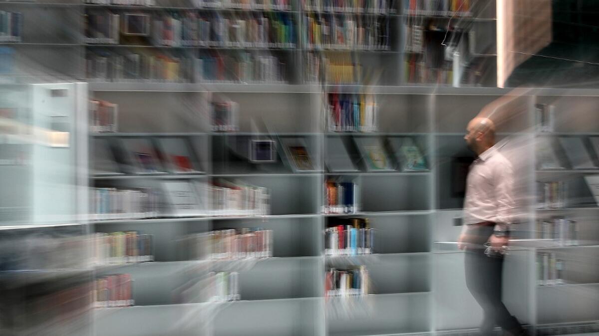 A man browses for books at the Qatar National Library in the capital Doha.  KARIM JAAFAR / AFP