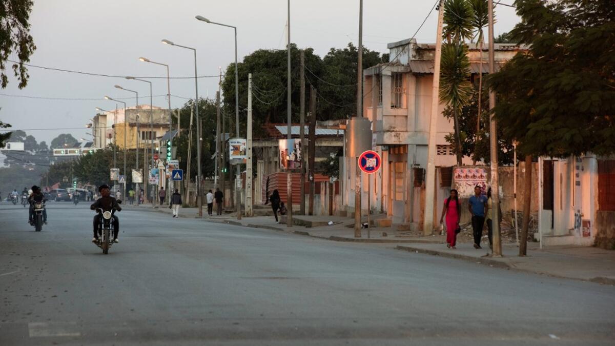 Motorcycles drive down a road in Kuito, Bie Province in Angola RODGER BOSCH / AFP