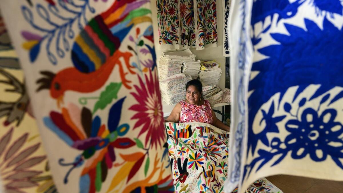 Mexican artisan Glafira Candelaria Jose, of the Otomi ethnic group, shows one of her designs at her workshop in San Nicolas village, in Tenango de Doria, Hidalgo state, Mexico.  Pedro PARDO / AFP