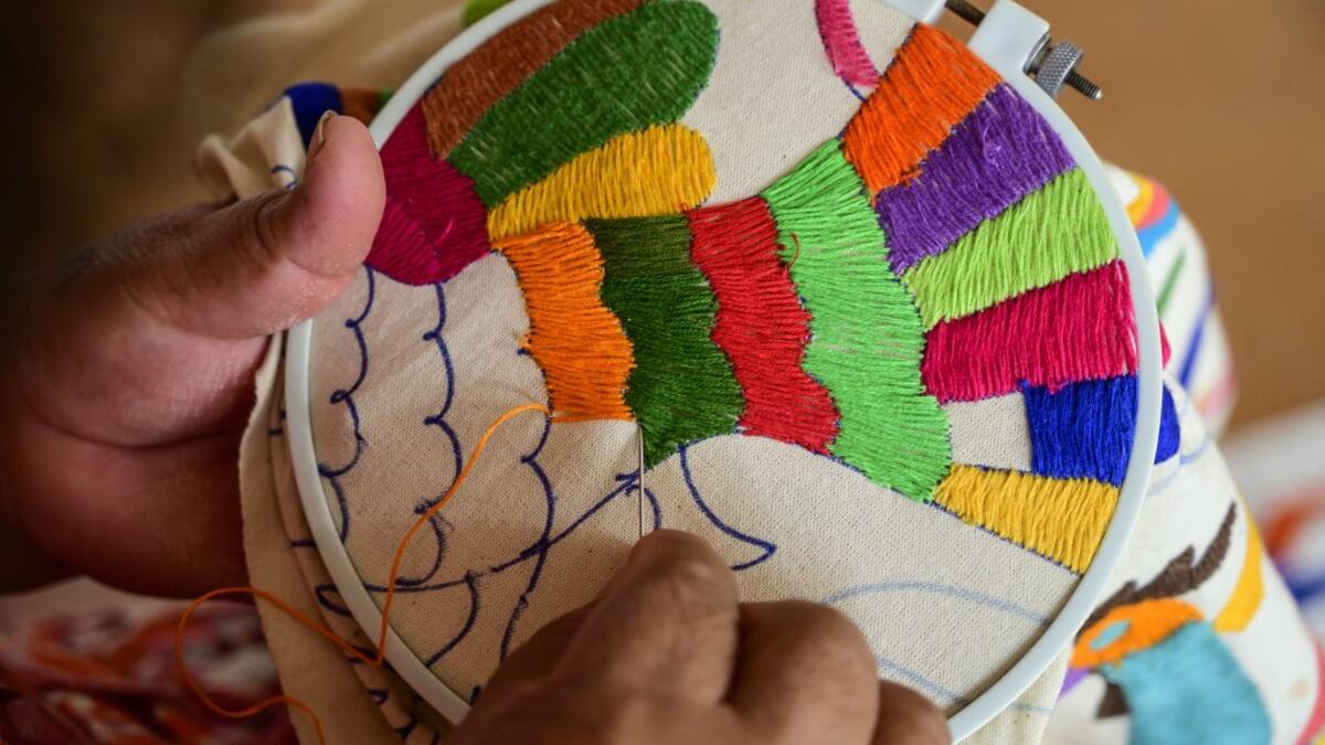 Mexican artisan Glafira Candelaria Jose, of the Otomi ethnic group, embroiders one of her designs at her workshop in San Nicolas village, in Tenango de Doria, Hidalgo state, Mexico.  Pedro PARDO / AFP