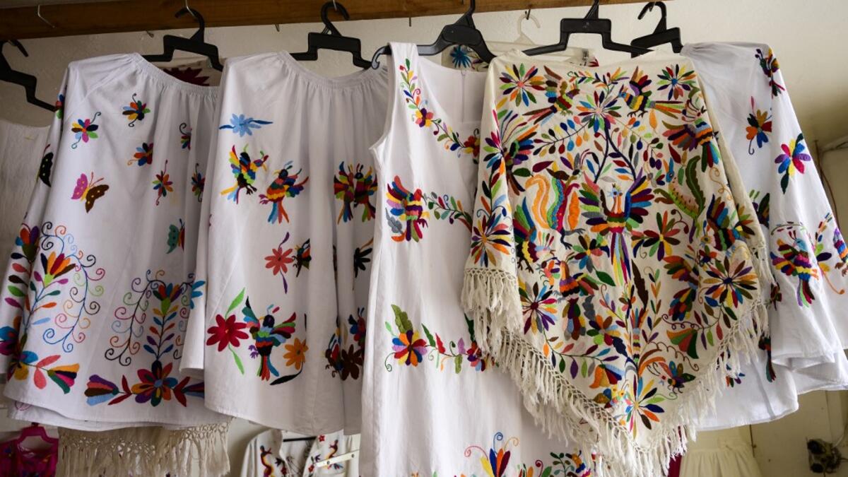 Mexican artisan of the Otomi ethnic group Oliver Teodoro Lopez, shows one of his designs at his workshop in San Nicolas Village, in Tenango de Doria, Hidalgo state, Mexico.  Pedro PARDO / AFP