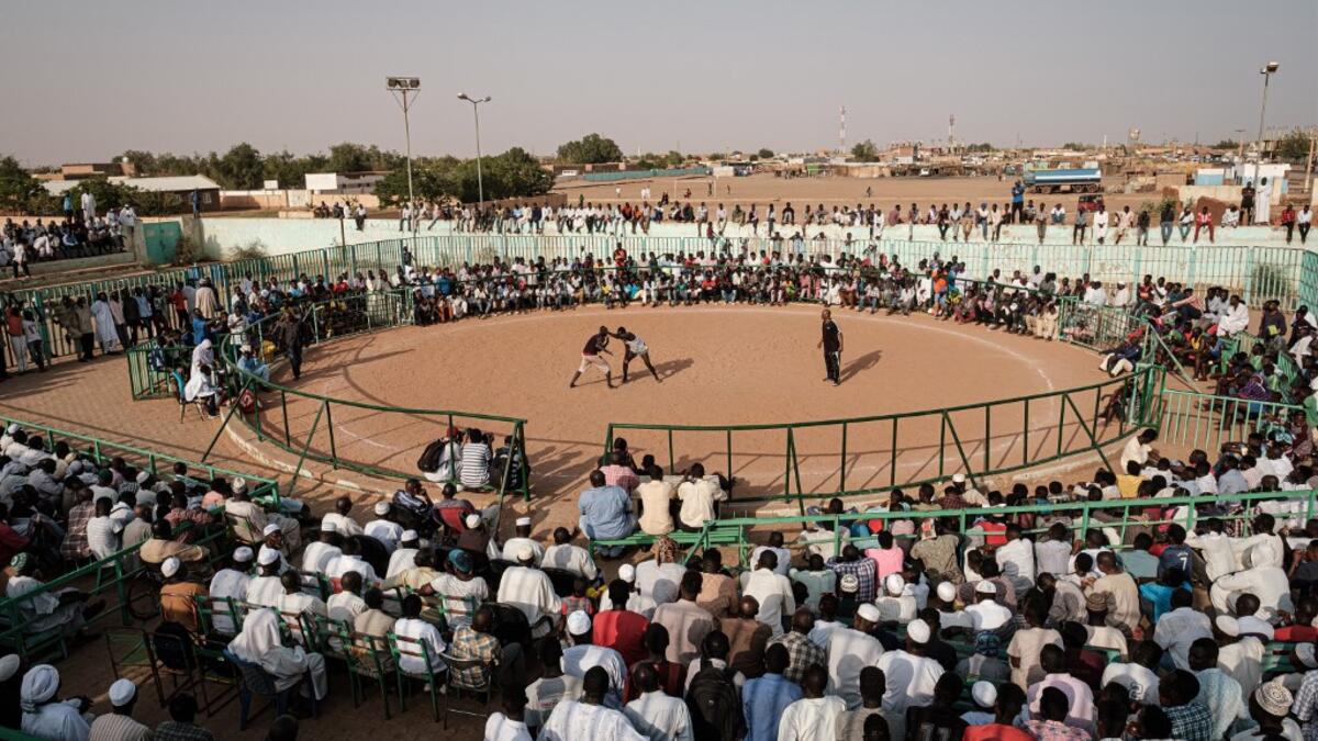 Sudanese wrestlers fight during a traditional Nuba wrestling match at the Haj Youssef stadium in the district of Khartoum.  Yasuyoshi CHIBA / AFP
