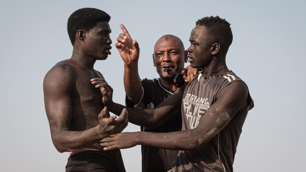 Sudanese wrestlers fight during a traditional Nuba wrestling match at the Haj Youssef stadium in the district of Khartoum.  Yasuyoshi CHIBA / AFP