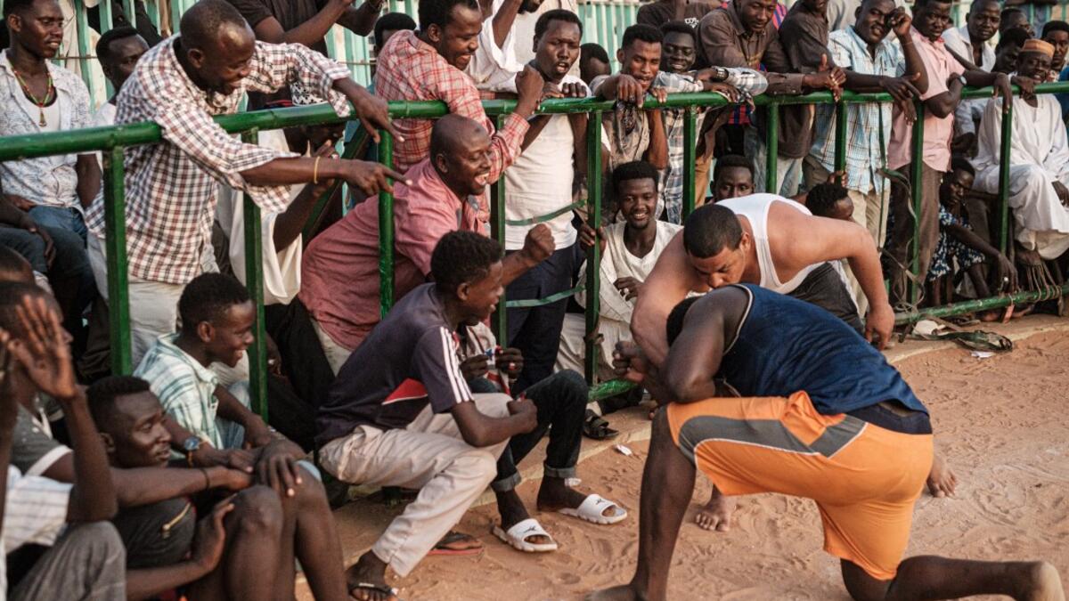 A Sudanese wrestler reacts after winning during a traditional Nuba wrestling match at the Haj Youssef stadium in the district of Khartoum.  Yasuyoshi CHIBA / AFP