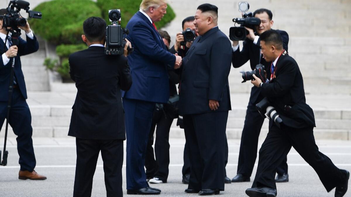 North Korea's leader Kim Jong Un shakes hands with US President Donald Trump north of the Military Demarcation Line that divides North and South Korea, in the Joint Security Area (JSA) of Panmunjom in the Demilitarized zone (DMZ) on June 30, 2019.  Brendan Smialowski / AFP