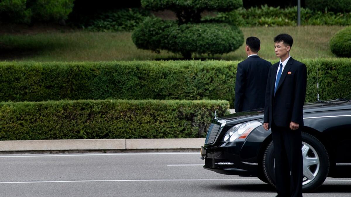 Members of North Korean security stands guard near a North Korean motorcade while US President Donald Trump and North Korea's leader Kim Jong-un meet in the Demilitarized Zone(DMZ) on June 30, 2019.  Brendan Smialowski / AFP