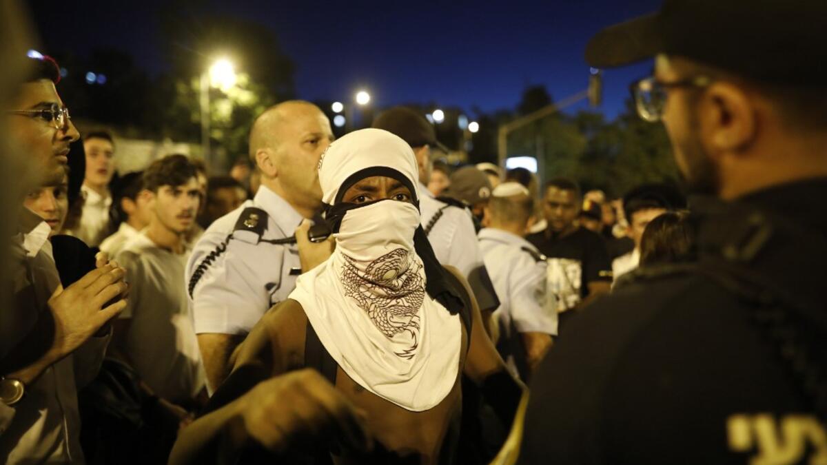 Crowds of Ethiopian-Israelis battled police and blocked highways in at least 10 junctions across the country beginning in the late afternoon, with over a dozen protesters detained and thousands of motorists held motionless in huge traffic jams.  MENAHEM KAHANA / AFP