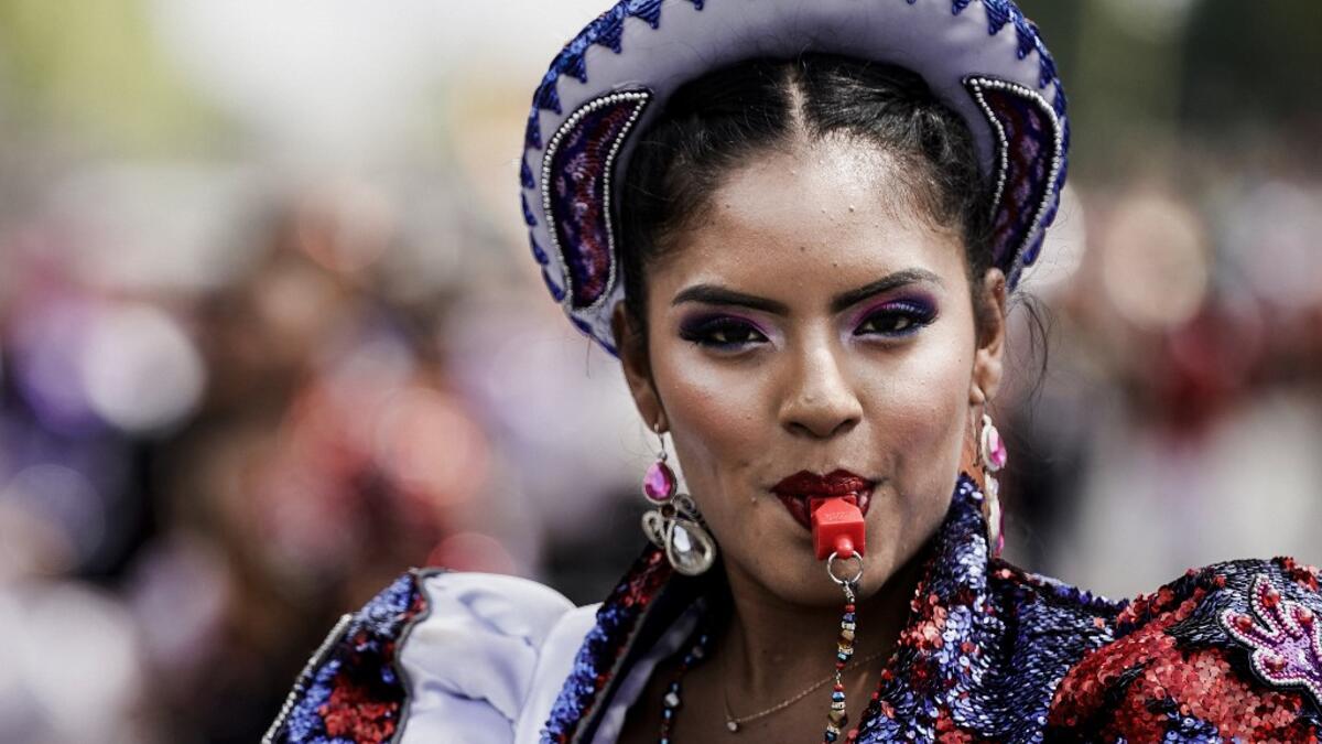People parade during the Tropical Carnival on July, 7 2019 in Paris.  Kenzo TRIBOUILLARD / AFP