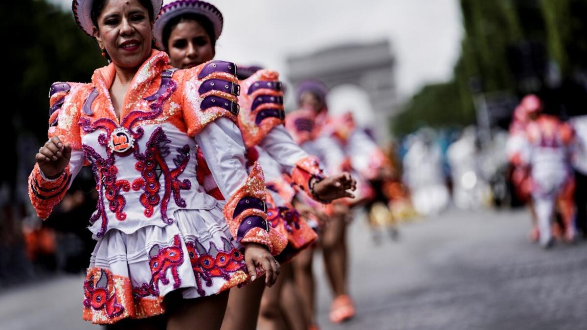 People parade during the Tropical Carnival on July, 7 2019 in Paris.  Kenzo TRIBOUILLARD / AFP