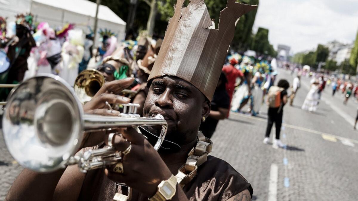 People parade during the Tropical Carnival on July, 7 2019 in Paris.  Kenzo TRIBOUILLARD / AFP