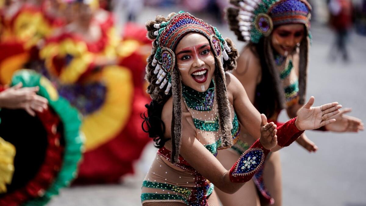 People parade during the Tropical Carnival on July, 7 2019 in Paris.  Kenzo TRIBOUILLARD / AFP