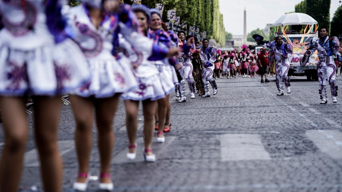 People parade during the Tropical Carnival on July, 7 2019 in Paris.  Kenzo TRIBOUILLARD / AFP
