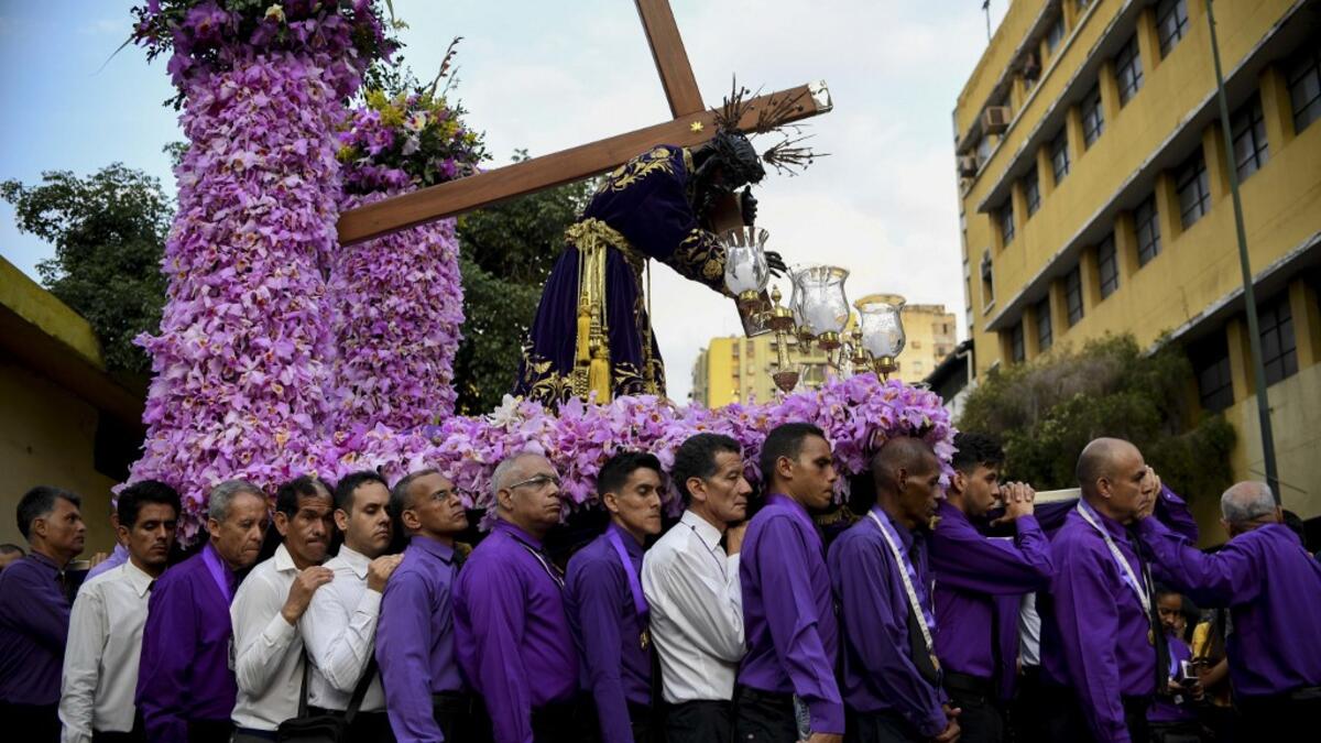 Catholic faithfuls take part in the traditional Nazareno de San Pablo (Saint Paul's Nazarene) procession in the framework of Holy Week celebrations in Caracas, on April 17, 2019.  YURI CORTEZ / AFP