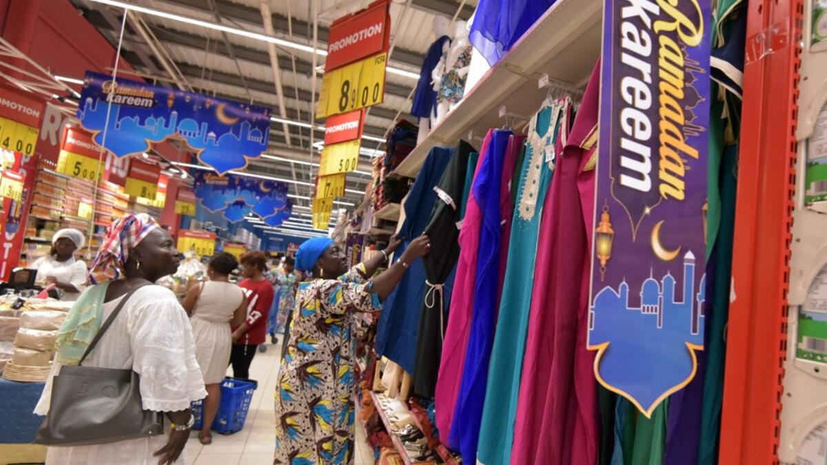 Women look at dresses at the Carrefour supermarket in Abidjan on May 4, 2019 on the eve of the start of the Ramadan, the Muslim holy month of fasting.  Sia KAMBOU / AFP