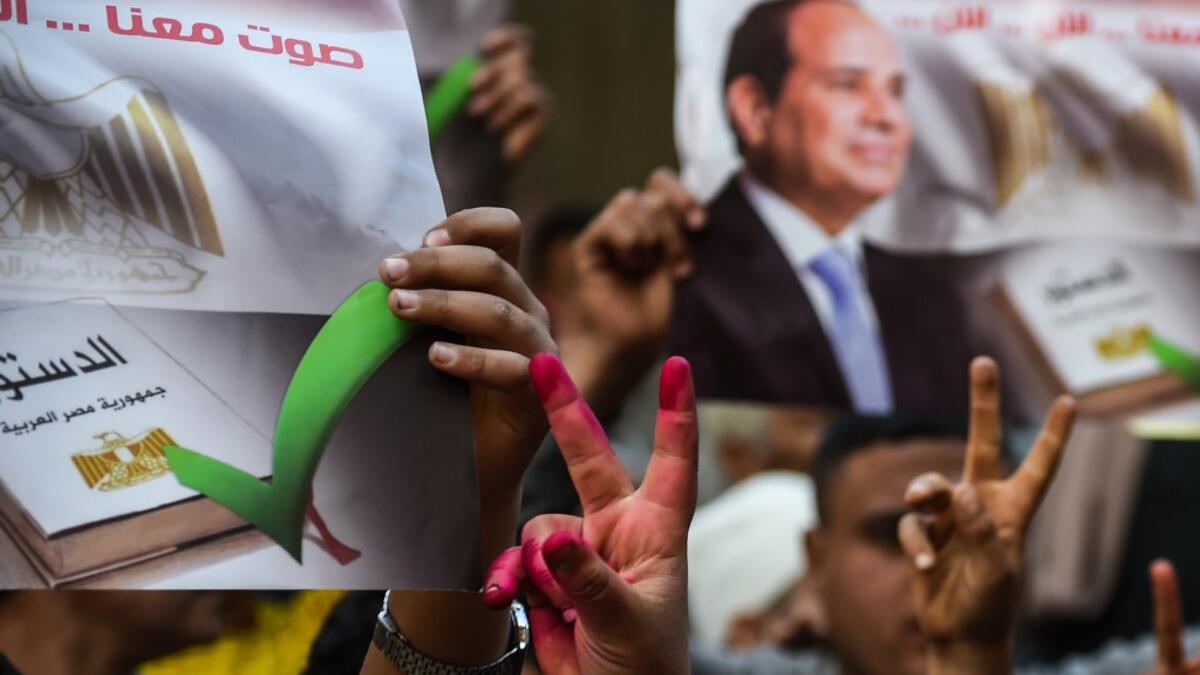 Egyptian people show their inked hands after voting at a polling station during the third day of a referendum on constitutional amendments, at a school in shamma village in the northern Nile delta province of Menoufia, on April 22, 2019.  Mohamed el-Shahed / AFP