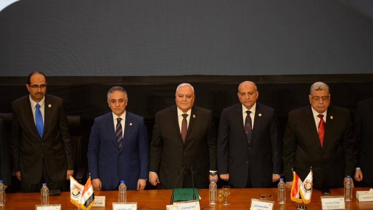 Members of the National Elections Commission (NEC) pose for a picture during a press conference in the Egyptian capital Cairo on April 23, 2019 to announce the result of the referendum extending the rule of President Abdel Fattah al-Sisi. Egypt referendum extending Sisi rule passed with 88.83% of vote. MOHAMED EL-SHAHED / AFP