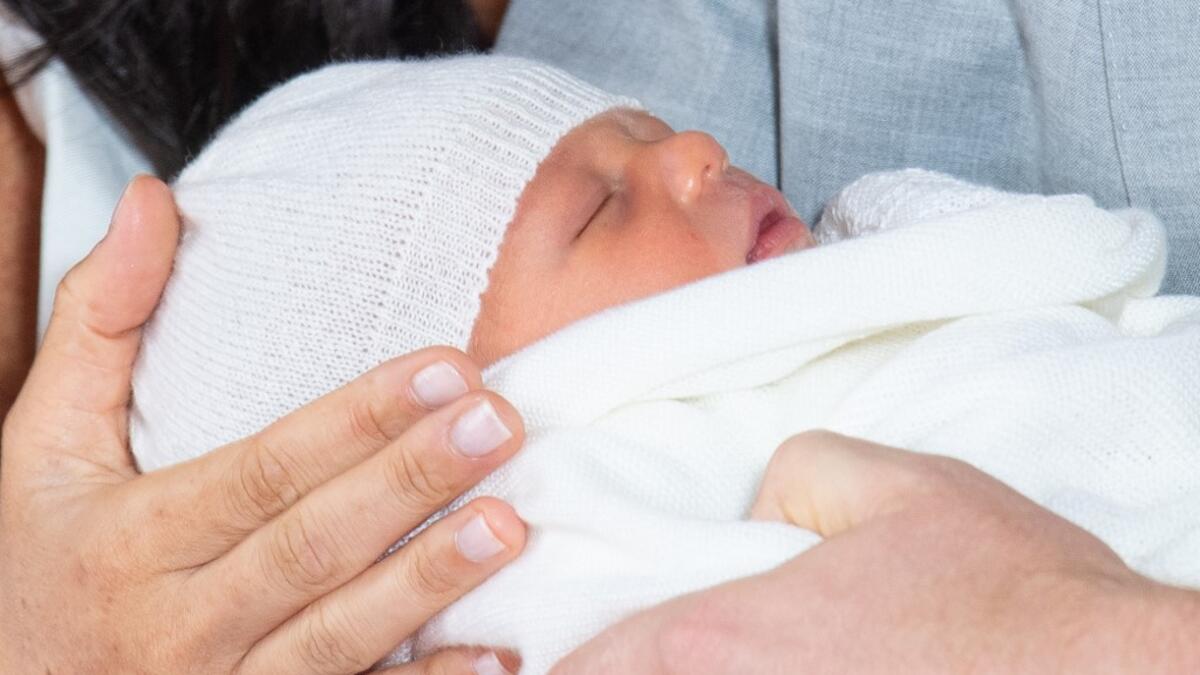 Britain's Prince Harry, Duke of Sussex (R), and his wife Meghan, Duchess of Sussex, pose for a photo with their newborn baby son, Archie Harrison Mountbatten-Windsor, in St George's Hall at Windsor Castle in Windsor, west of London on May 8, 2019.  Dominic Lipinski / POOL / AFP