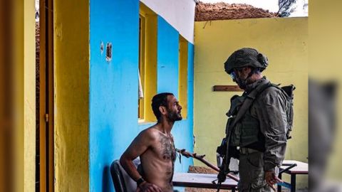 Israeli soldier shares picture of himself torturing man in Gaza